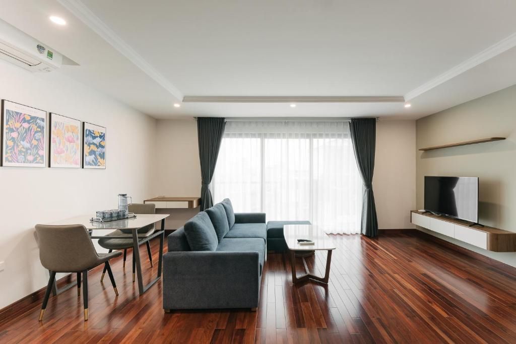 Una sala de estar moderna con sofá, mesa de centro y mueble para televisión.