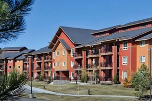 A multi-story residential building with balconies, a flat roof, and a clear sky. - Steamboat Ski Week • 2BR Condo • Sleeps 6 • Feb 1–8, 2027 •Winter Carnival (Steamboat Springs)