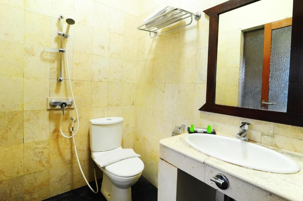 Un baño con inodoro, lavabo y ducha.