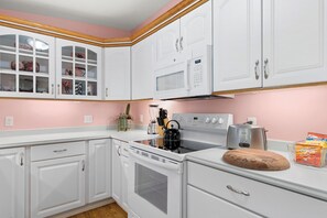 A kitchen with white cabinets, a microwave, an oven, a toaster, and a blender on the counter. - Steps to Oak Creek – A Peaceful Sedona Retreat Near Cathedral Rock (Sedona)
