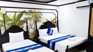 A hotel room with two single beds, a large window with a view of palm trees, and a ceiling-mounted air conditioning unit. - Gia Bao Hotel Near Tan Son Nhat Airport (Tân Bình)