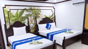 A hotel room with two beds, a large window with a view of greenery, and a ceiling-mounted air conditioning unit. - Gia Bao Hotel Near Tan Son Nhat Airport (Tân Bình)