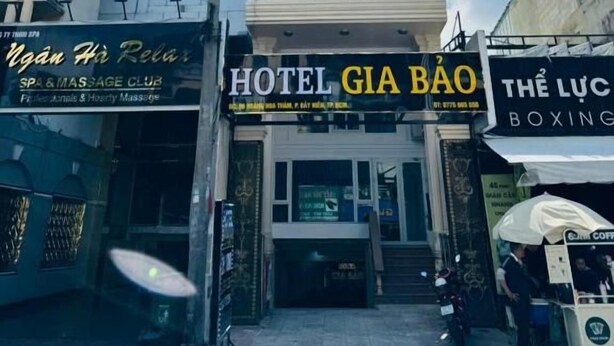 A hotel with a modern facade, a visible entrance, and signage for a massage club and boxing gym. - Gia Bao Hotel Near Tan Son Nhat Airport (Tân Bình)