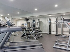 A gym with treadmills, weight machines, and dumbbells. - Club Wyndham Desert Rose Resort (Las Vegas)
