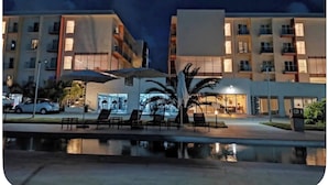 A hotel with multiple floors, outdoor seating, and a pool area. - Modern Maho Studio Near Mullet Bay & Maho Beach (Maho)
