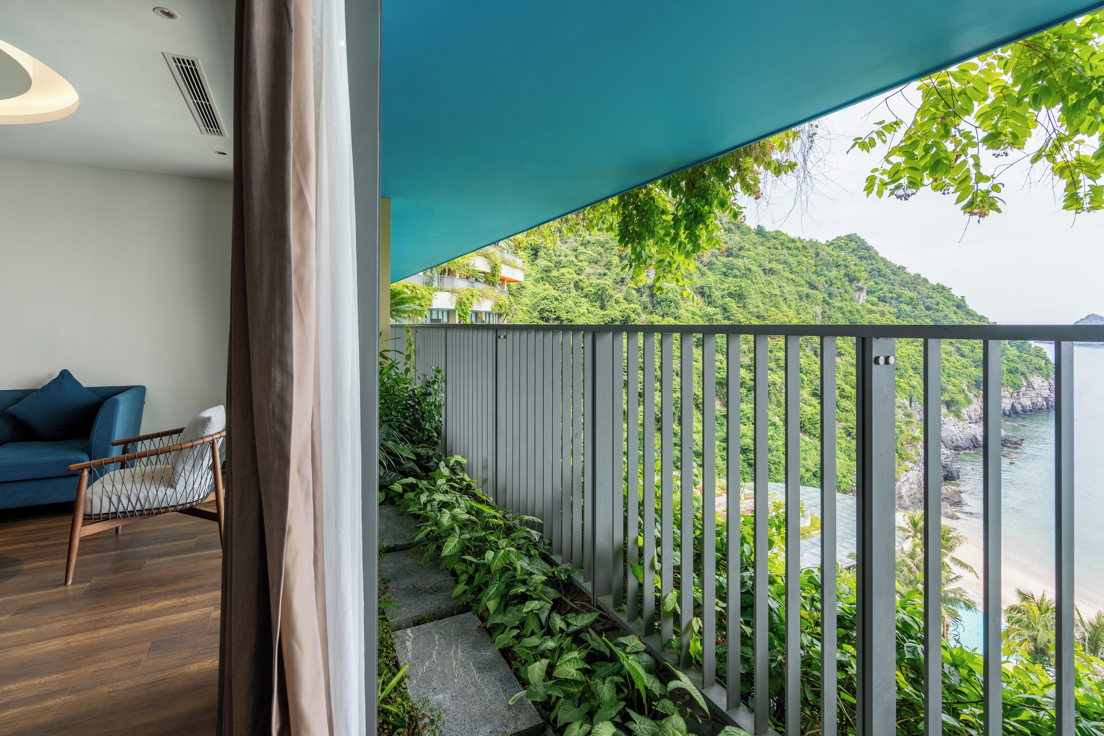 A balcony with a view of a mountainous landscape and a body of water.