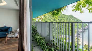 A balcony with a view of a mountainous landscape and a body of water.