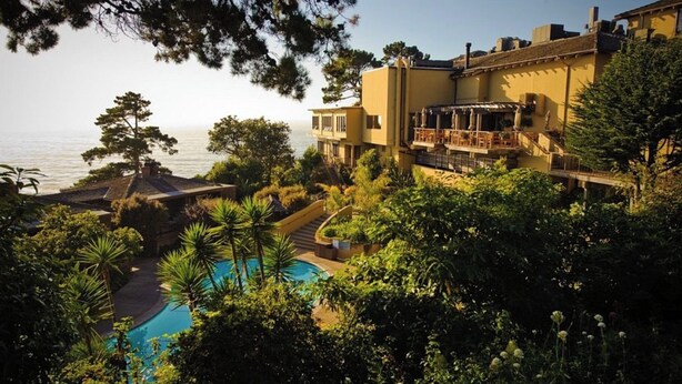 A resort with a pool, outdoor seating, and a view of the sea. - Hyatt Highlands Inn Spa Townhome Sept 19-26, 2026, Carmel Highlands, ocean view (Carmel)