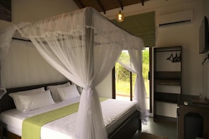 A bed with a canopy, a bedside table, and a shelf unit.