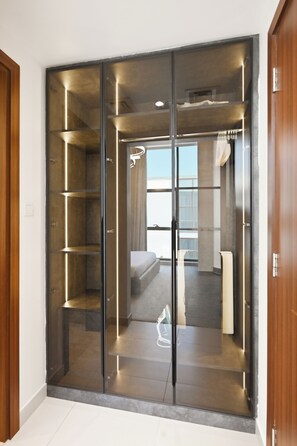 A modern interior with a sliding glass door closet, a bed, and a view of the outside. - Luxury 5-Bedroom Townhouse with Private Pool in Dubai (Dubai)