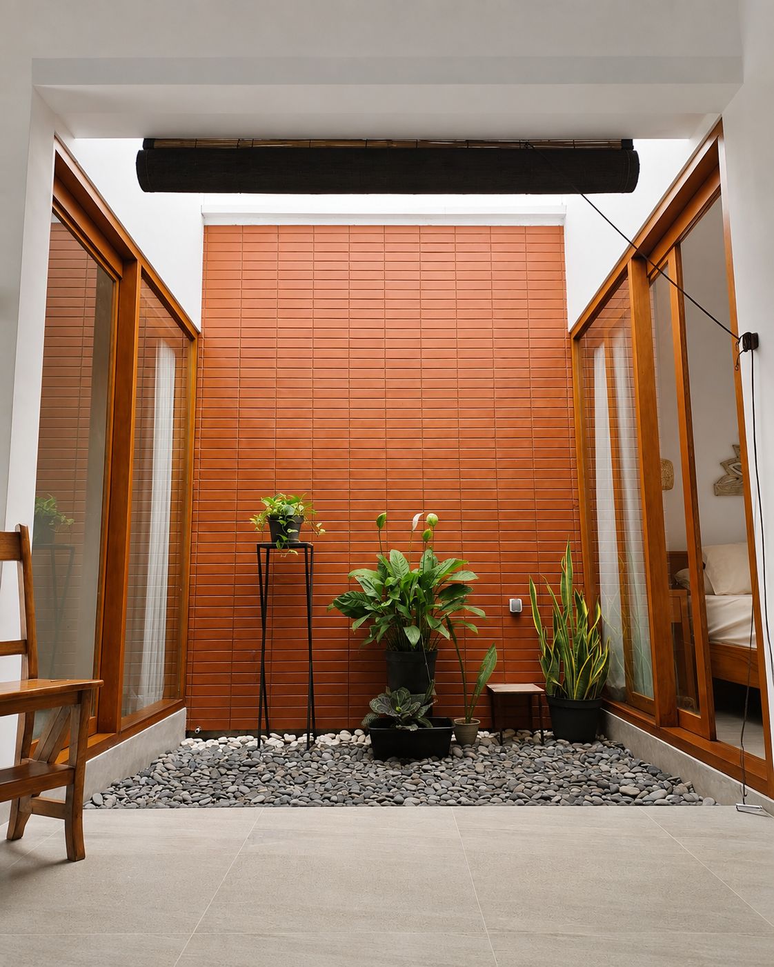 A modern interior with a wooden partition, potted plants, and a seating area.