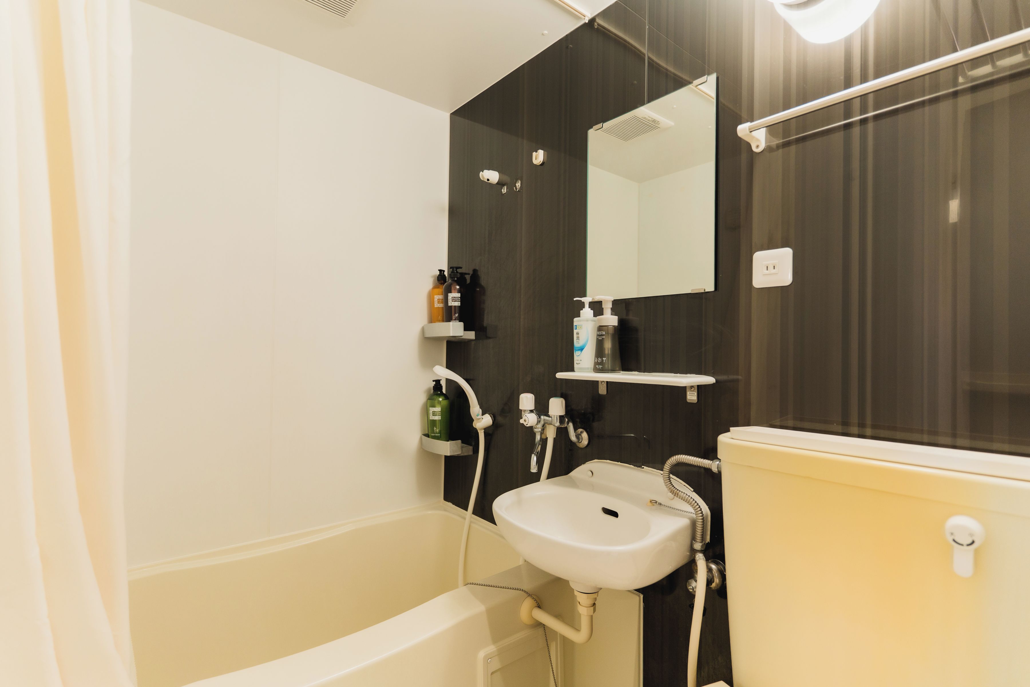 A modern bathroom with a bathtub, a sink, and a mirror.