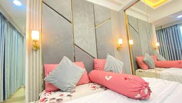 A modern bedroom with a large bed, a headboard with geometric patterns, and a full-length mirror.