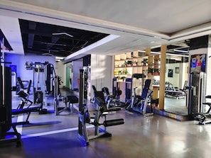 A gym with various exercise equipment, including treadmills and weight machines.