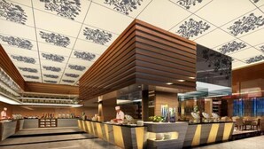A modern hotel lobby with a reception desk, seating area, and a decorative ceiling. - Grand Skylight International Hotel Ganzhou (Ganzhou)