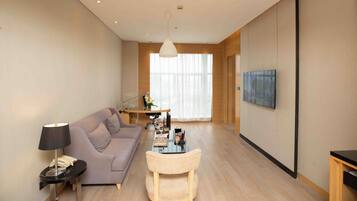 A modern living room with a sofa, coffee table, and TV.