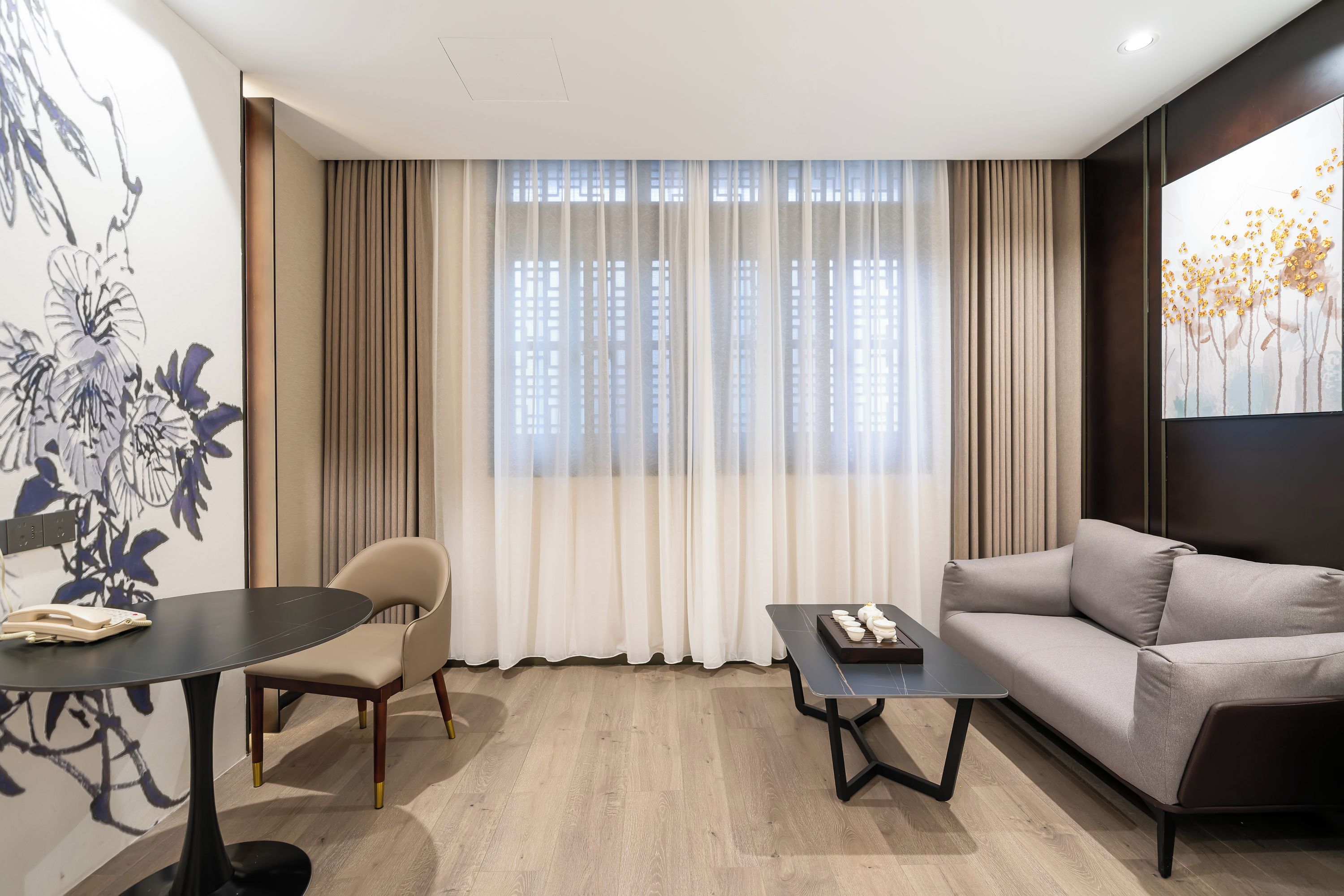 A modern living room with a sofa, a dining table, and a chair.