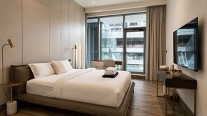 A modern hotel room with a large bed, a desk, and a view of the city. - Designer Duplex PrivatePool, Large Patio (Dubai)