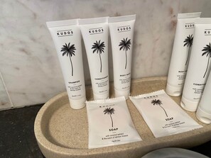 A set of skincare products including shampoo, conditioner, body wash, and soap, all branded with coconut and tropical scents.