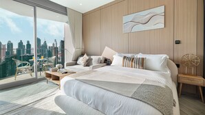 A modern bedroom with a large bed, a sofa, a coffee table, and a view of the cityscape. - High Floor Luxury Burj Khalifa & Canal View Studio (Dubai)