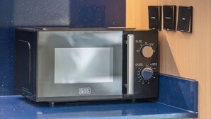 A microwave with a digital display, control knobs, and a brand name. - High Floor Luxury Burj Khalifa & Canal View Studio (Dubai)
