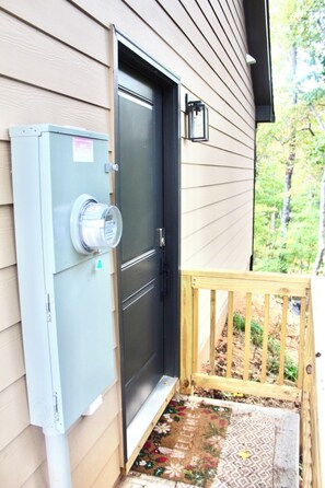 A utility meter box mounted on a wall next to a door. - Studio  located inside Paradise Valley Resort & Club. A Clothing Optional Club. (Dawsonville)