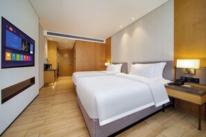 A hotel room with a large bed, bedside tables, a desk, and a television displaying a menu. - The Skytel Hotel Heyuan (Heyuan)