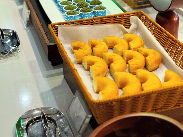 A wicker basket filled with pastries on a table.