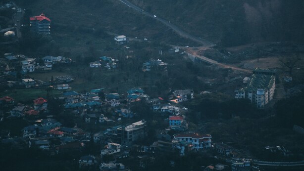 An aerial view of a stadium surrounded by residential buildings. - Mountain Monk (Kalpa)