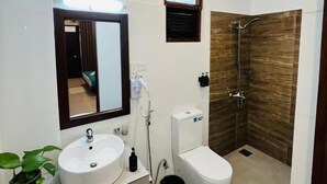 A modern bathroom with a double sink, a toilet, and a shower area. - Hiri point villa (Dikwella)