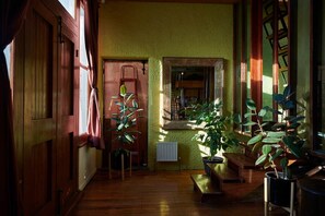 A room with wooden flooring, a radiator, and potted plants. - Central City Warehouse Apartment (Melbourne)