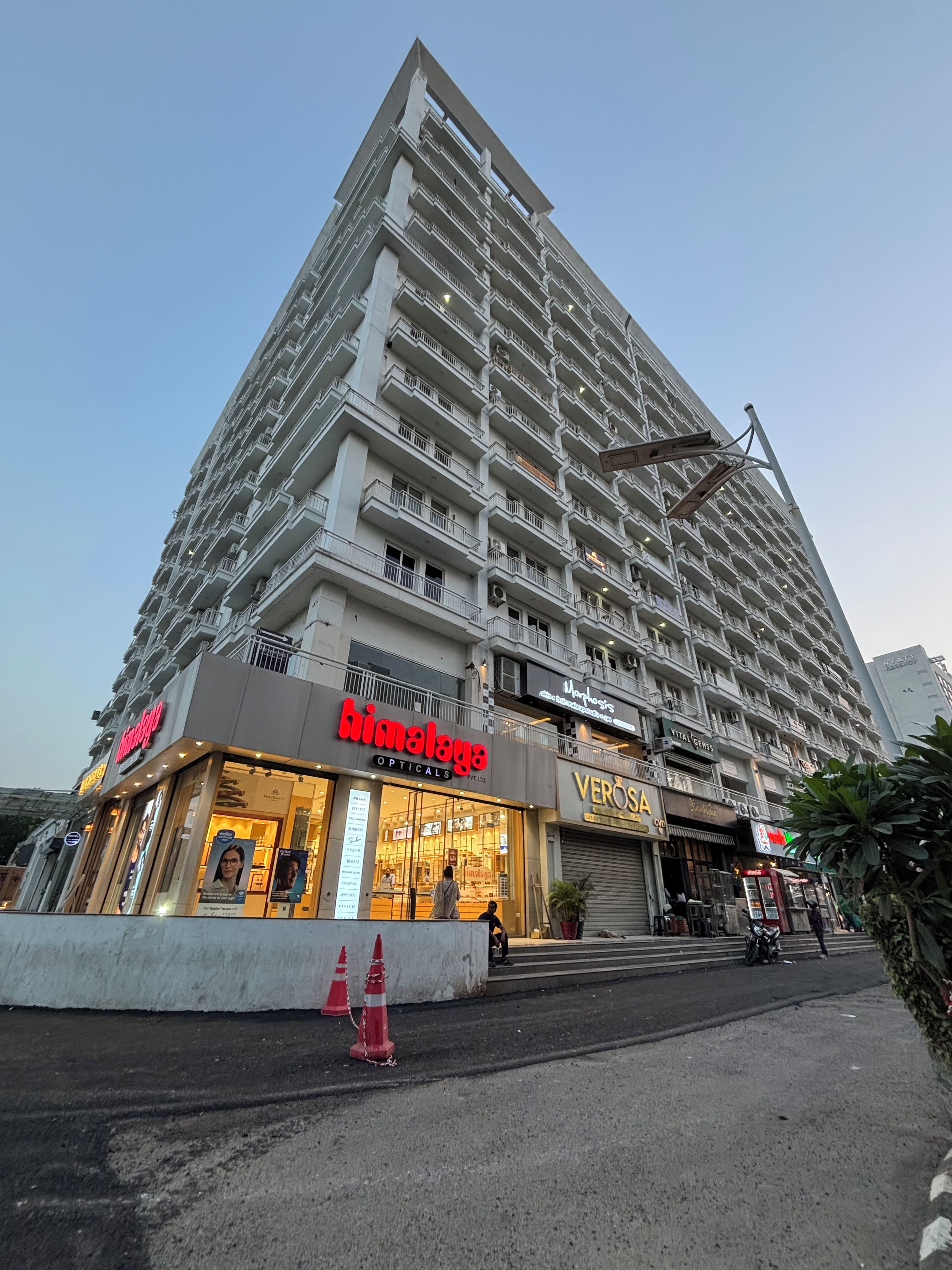 A multi-story hotel with a prominent 'Himalaya Opticals' store on the ground floor.