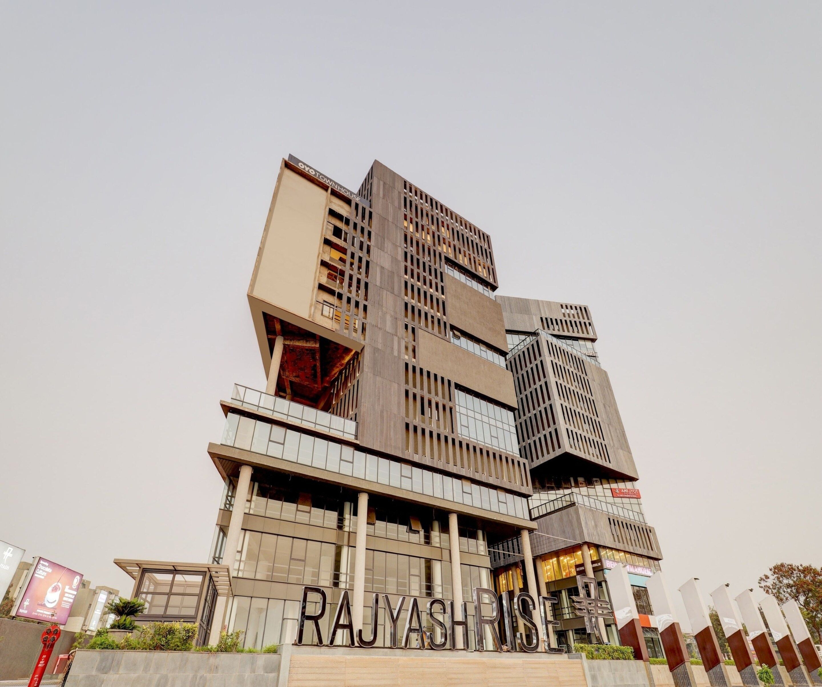 Een meerhoog gebouw met een opvallend bord waarop 'RAJYASHRI' staat.