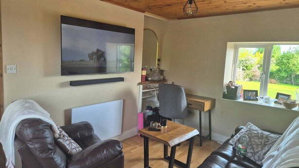 A living room with a television, a desk, a chair, and a sofa. - Cottage on the hillx (Ballon)