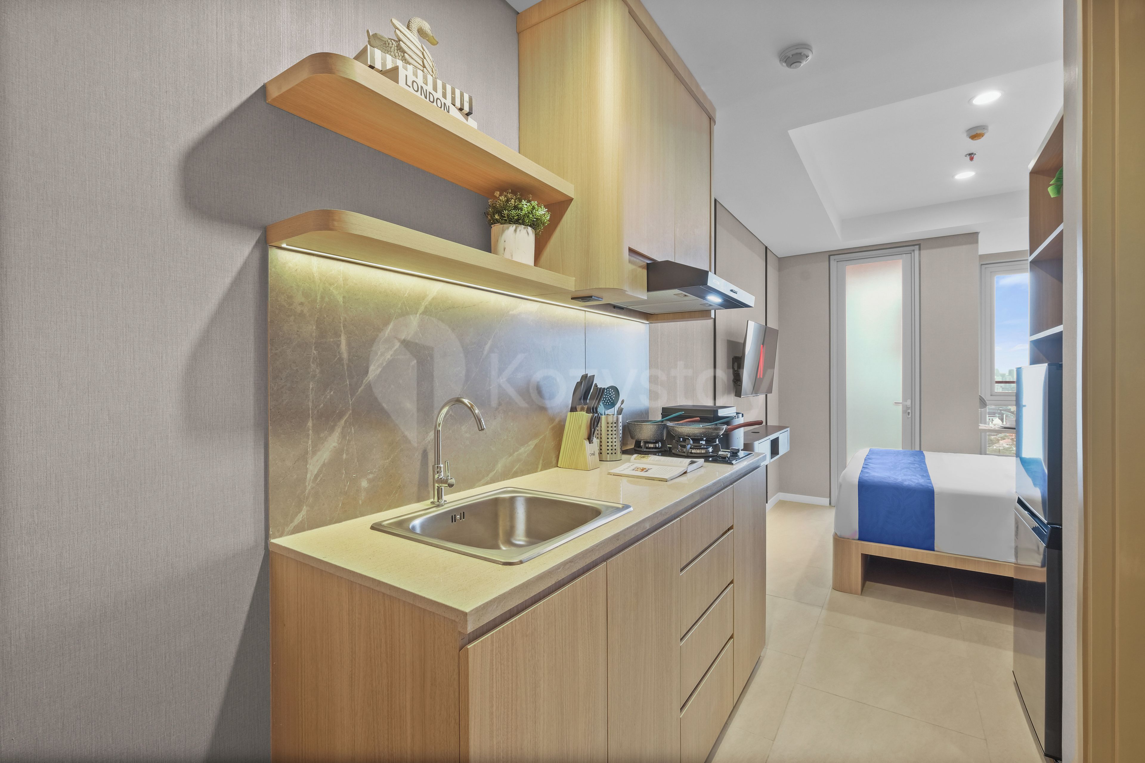 A modern kitchen with a built-in oven, a sink, and a stove.