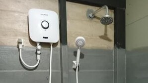A shower with a handheld showerhead and a wall-mounted control panel. - Hiriketiya Budget Stay (Dikwella)
