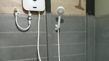 A shower with a handheld showerhead and a wall-mounted faucet.