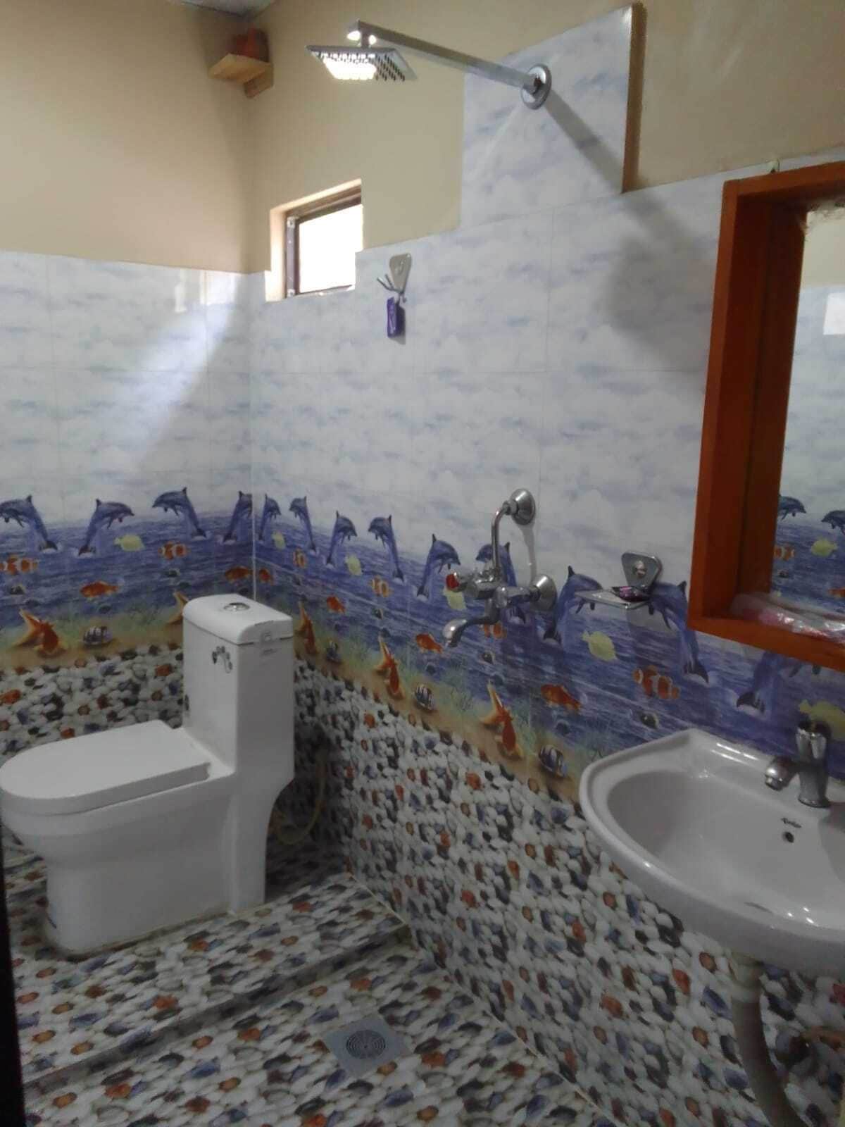 A bathroom with a toilet, sink, and shower.