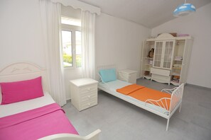 A child's bedroom with a bed, a nightstand, a dresser, and a wardrobe. - Beachfront Big Villa (Çeşme)
