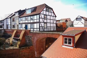 A traditional half-timbered building with a brick wall and a small window. - Lady of the Lake||Tangermünde (Tangermünde)