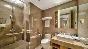 A modern bathroom with a glass-enclosed shower, a toilet, and a vanity with a mirror. - Grand Skylight X-INN Inn Pingshan (Shenzhen)