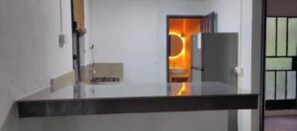 A modern interior with a glass partition, a door leading to another room, and a visible light fixture.