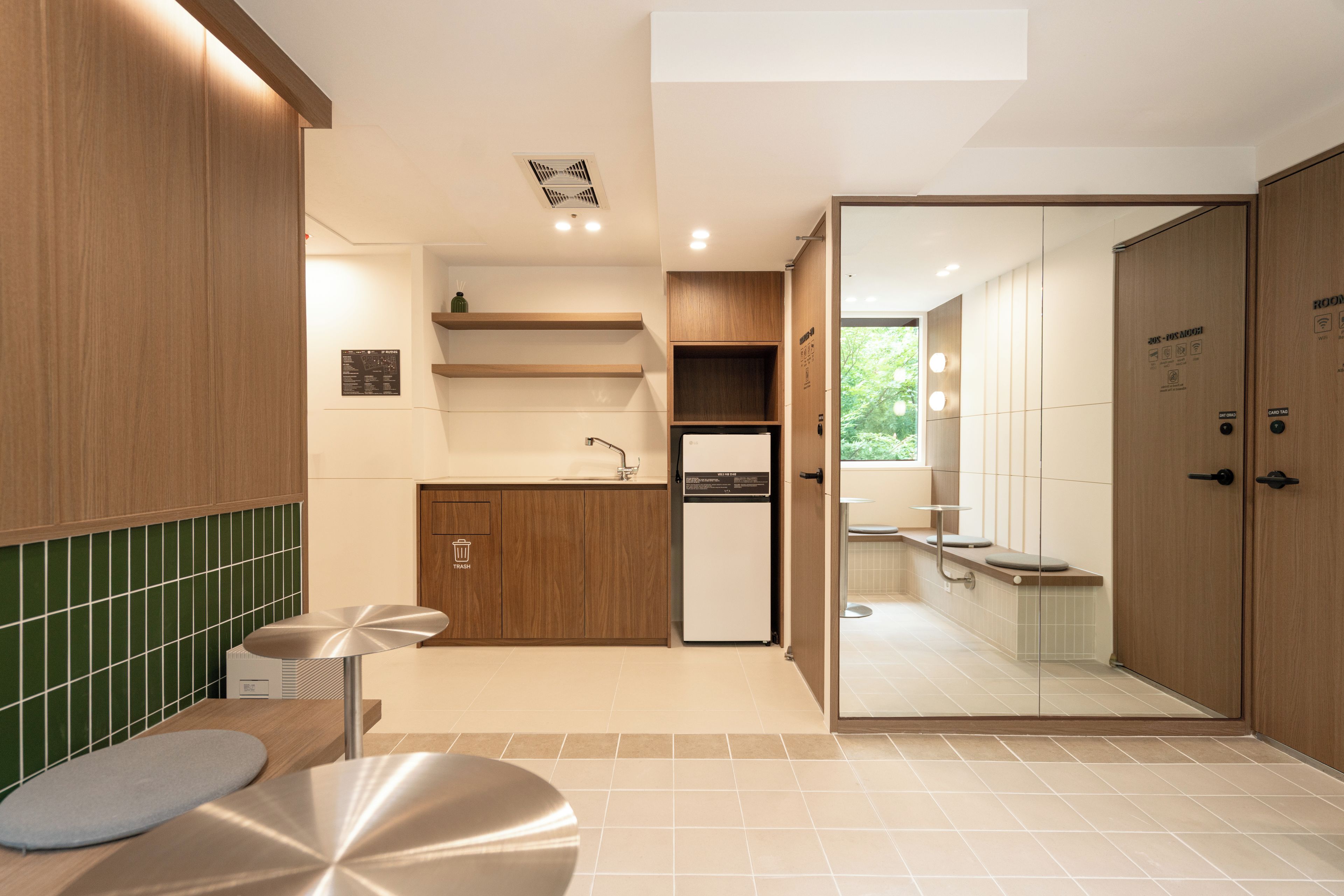 A modern bathroom with a shower, toilet, and sink.