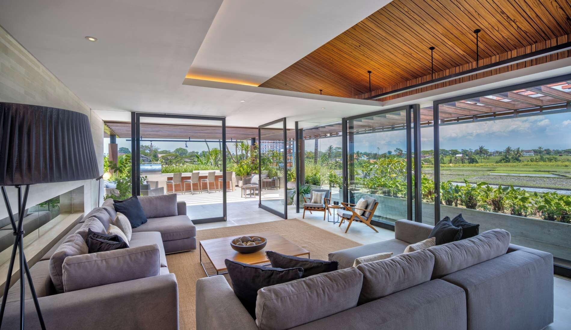A modern living room with a large sofa set, a coffee table, and a television.