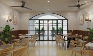 Et restaurantinteriør med høje lofter, ventilatorer i loftet og en stor buet glasdør, der fører til en udendørs siddeplads.