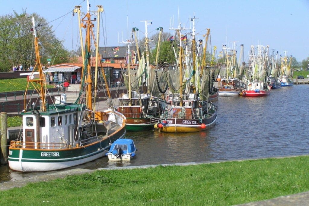 A harbor with multiple boats docked along the water.