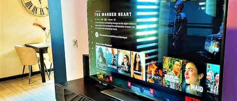 A television displaying a Netflix interface with multiple show options.