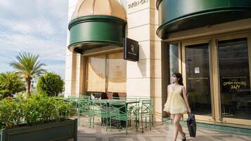 A building with a sign that reads 'SUON CAY' and a sign for 'REGAL BISTRO' outside.