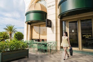 A building with a sign that reads 'SUON CAY' and a sign for 'REGAL BISTRO' outside.