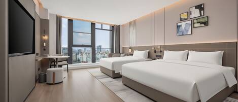 A modern hotel room with a large bed, a desk, and a view of the cityscape.